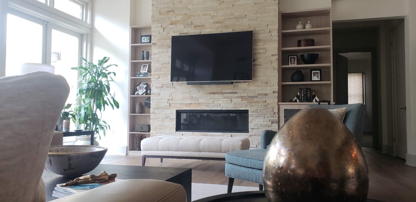 TV mounted above a linear fireplace feature wall in an upscale Las Vegas living room